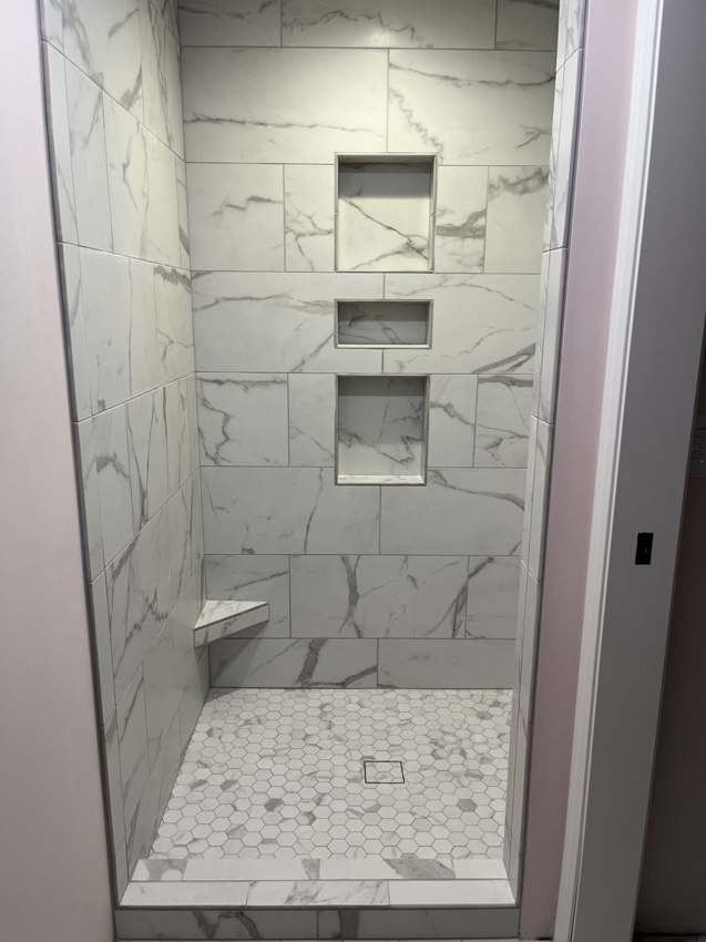 Finished marble shower with recessed niches