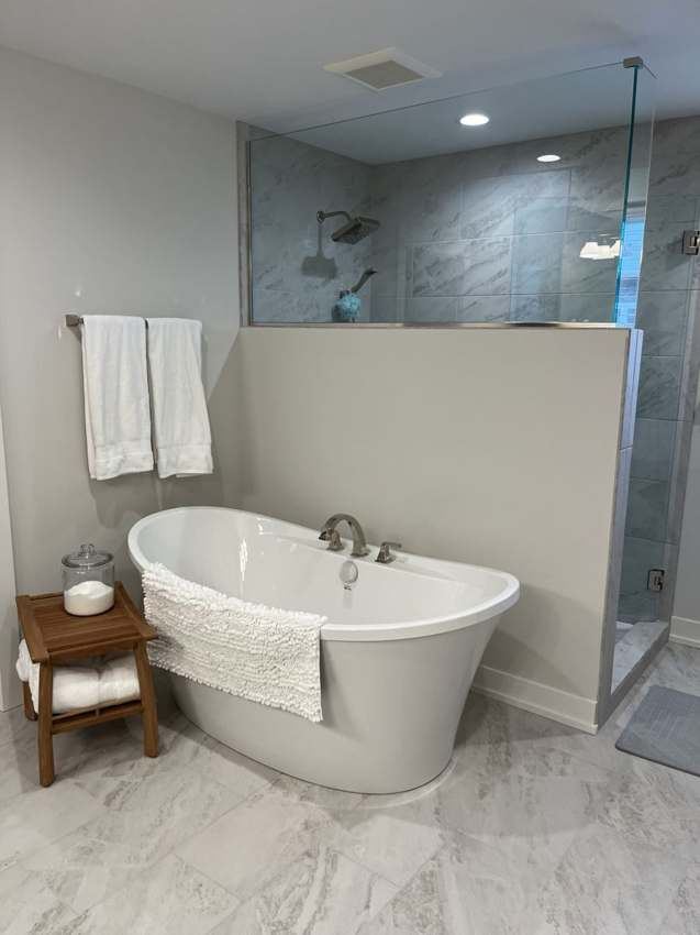 Finished bathroom with freestanding bathtub and custom tile installation